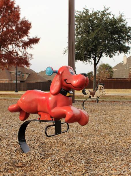 A Dog and horse spring toy on vacant park in Autumn