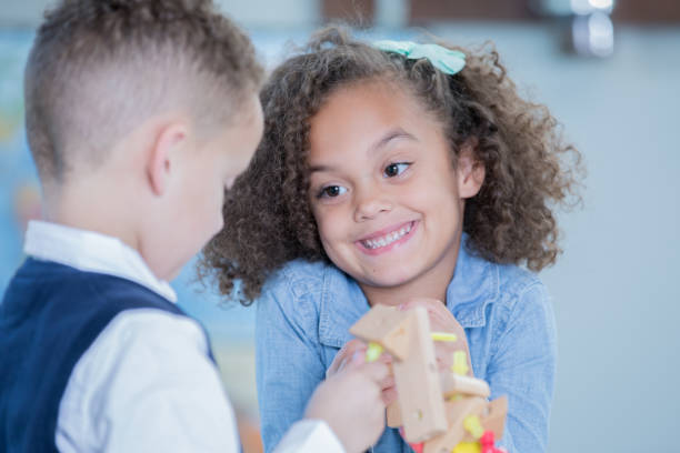 istock Preschool age boy and girl build something with blocks during STEM class 1081207752