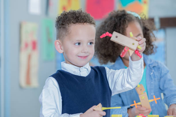 istock Adorable little boy building something with STEM educational toy blocks in classroom 1081207760