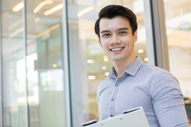 istock Young businessman carries folder outside his office 1081224940