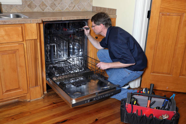 istock Appliance repairman works on broken dishwasher 1081225652