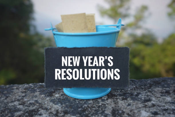 Inspirational and conceptual wording. New Year concept. ‘New year’s Resolutions‘ written on a black paper.With vintage styled background. 2019 new year resolution stock pictures, royalty-free photos & images