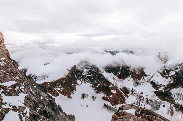 istock Titlis rock cliff behind cloud and deep snow mountain valley 1081233524