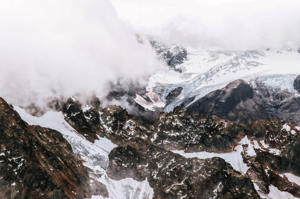 istock Titlis rock cliff behind cloud and deep snow mountain valley 1081233530