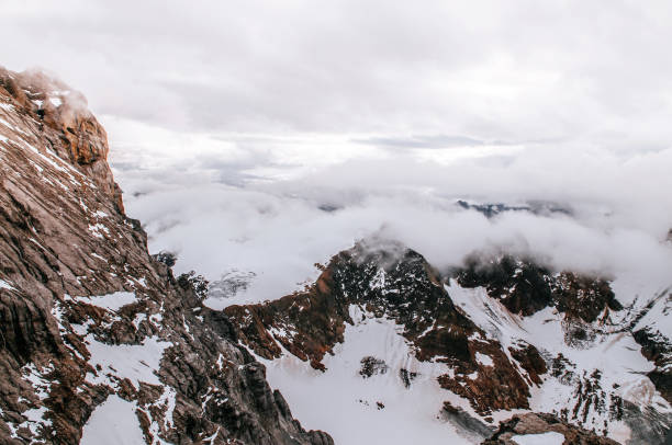 istock Titlis rock cliff behind cloud and deep snow mountain valley 1081233540