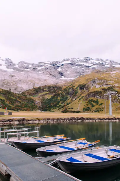 Rural landscape scenery with row boats in Trubsee lake, recreation activity of Swiss alps and foot of mount Titlis area  in Engelberg