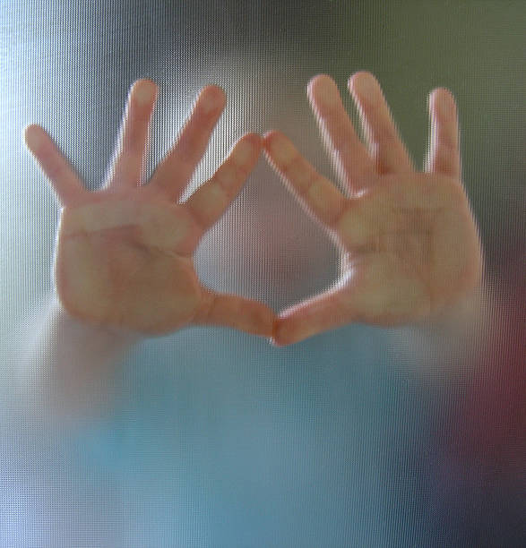 Hands reaching out from a blurred image of a child stock photo