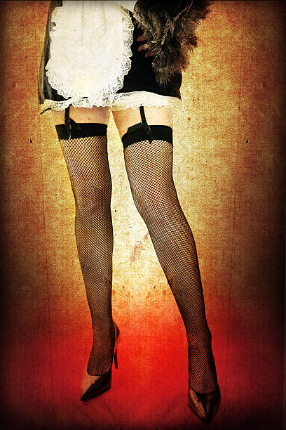 woman's legs in medias de liga de malla y disfraz de criada - maid french maid outfit sensuality duster fotografías e imágenes de stock