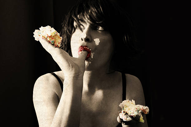 Pretty blonde girl eating chocolate Cake. Indoor lifestyle portrait of woman in sunglasses.  White background, not isolated