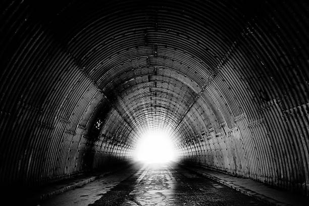 Black and White of Tunnel light in the end of a tunnel (little grain added, B&W) tunnel stock pictures, royalty-free photos & images