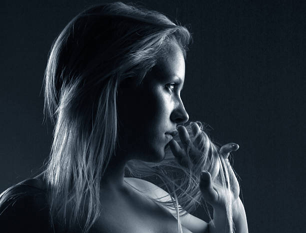 istock Young Woman Running Hand Through Hair and Touching Lips 108125508