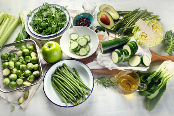 Green vegetables for healthy cooking Green vegetables for healthy cooking. Vegetarian and vegan food. Healthy diet eating concept. Top view, flat lay salad fruit lettuce spring stock pictures, royalty-free photos & images