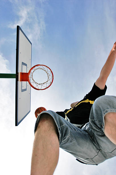istock Looking Up at Man Dunking Basketball 108125600