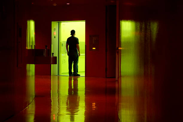 istock Young Man Walking Into an Elevator from Dark Hallway 108125623