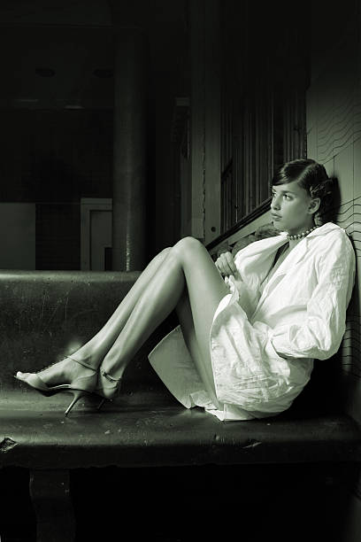 istock Young Woman Posing and Sitting on Wooden Bench 108125901