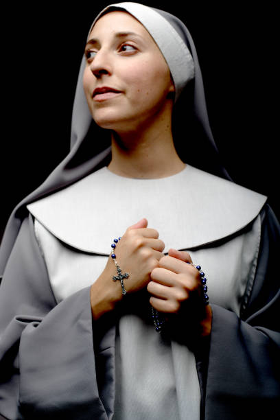 Portrait of Nun Holding Rosary Beads  nun catholicism sister praying stock pictures, royalty-free photos & images