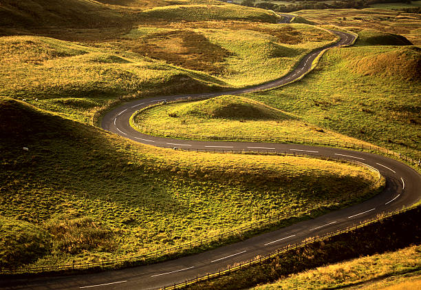 Road Snaking Through Landscape  peak district national park photos stock pictures, royalty-free photos & images