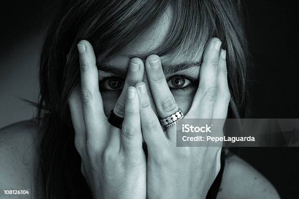 Portrait Of Young Woman Hiding Face In Hands Toned Stock Photo - Download Image Now