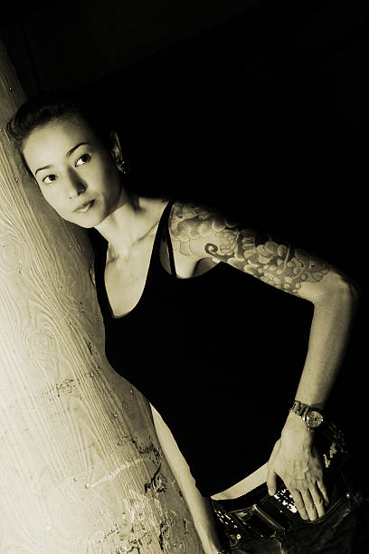 istock Young Woman Leaning Against Concrete Column, Sepia Toned 108126133