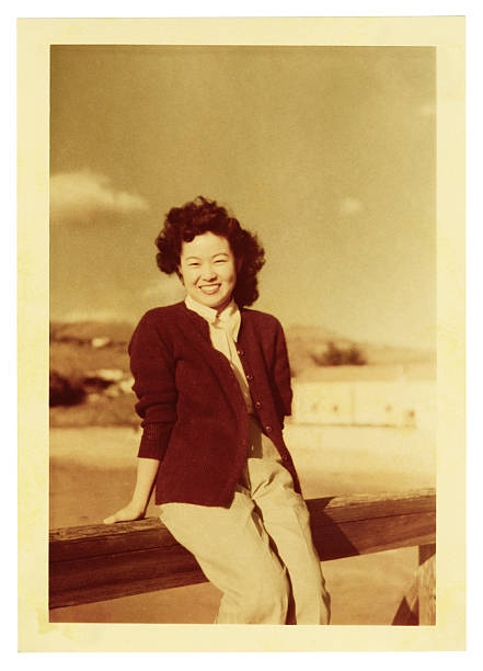 Asian Woman Sitting on a Railing stock photo