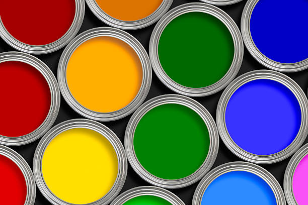 Open multi-colored paint tins from above stock photo