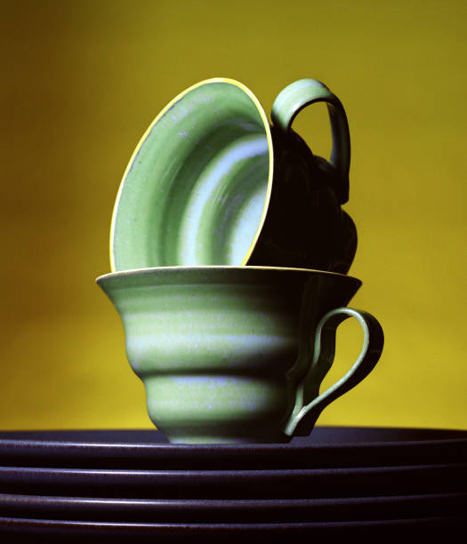 istock Stacked Teacups and Plates on Yellow Background 108126642