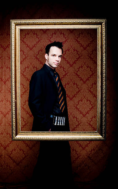 istock Young Man Wearing Suit and Posing Inside Picture Frame 108126649