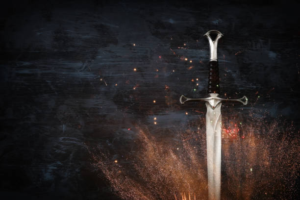 istock low key image of silver sword with fire sparks. fantasy medieval period. 1081266978