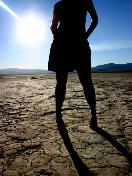 Silhouette of Woman in Desert stock photo