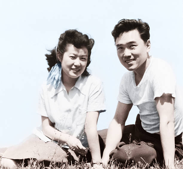 istock Young Asian Couple Sitting on Grass 108126899