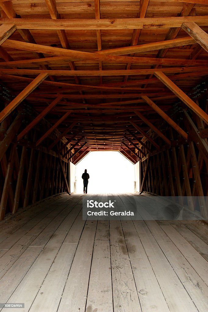 Silhueta de Pessoas caminhando pela ponte coberta de madeira - Foto de stock de Andar royalty-free
