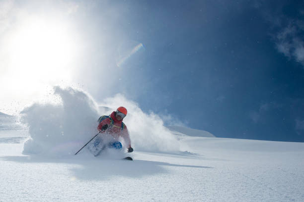 Powder skiing Heli skiing in deep powder. extreme skiing stock pictures, royalty-free photos & images