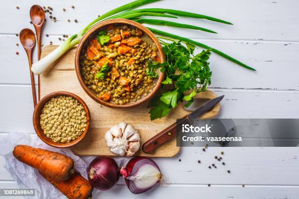 Lentil Soup In A Wooden Bowl And Ingredients On A White Wooden Background Top View Stock Photo - Download Image Now