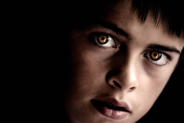 istock Portrait of Young Boy with Intense Eyes, Low Key 108127020