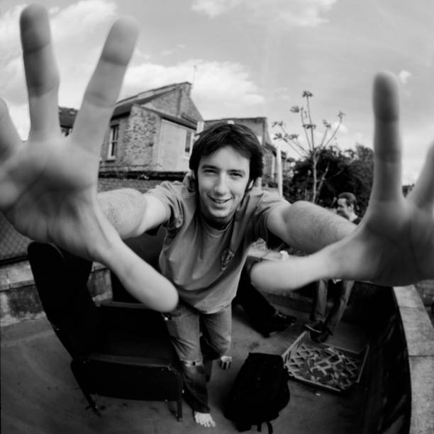 istock Young Man Holding Hands Up, Fish Eye Black and White 108127116