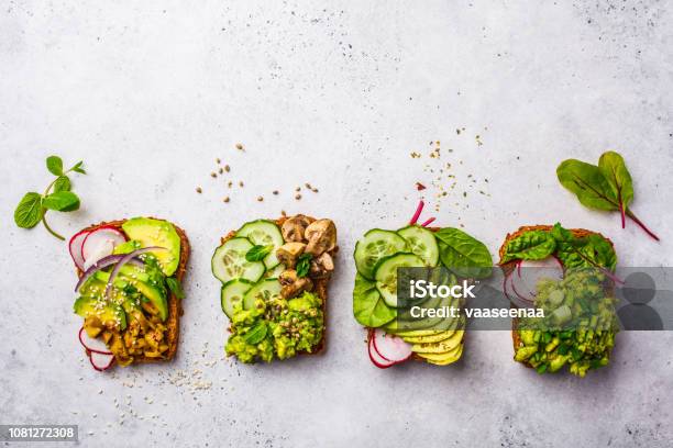 Avocado Toasts With Different Toppings Top View White Background Copy Space Stock Photo - Download Image Now