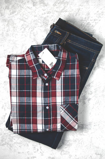 istock Checkered shirt and blue jeans on a gray background 1081272616