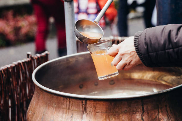 istock Pouring hot beverage called  Punsch in German language into a glass with a huge kitchen spoon. Favourite hot drink at Christmas markets in Switzerland and in german-speaking countries. Keeping warm at cold temperatures. 1081278652