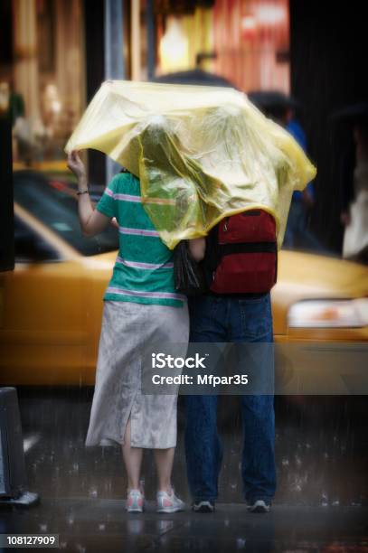 Couple Under One Cover In The Rain Stock Photo - Download Image Now - Rain, Taxi, Waiting