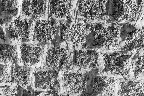 Black and white background of ancient stone wall. Texture of old brick. Monochrome.