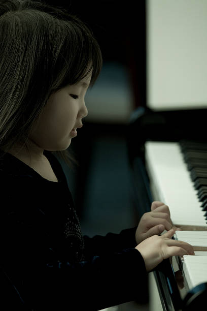 istock Young girl playing a piano 108128218