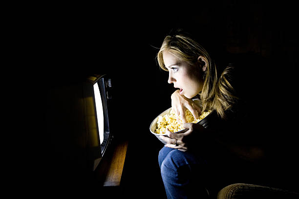 istock Young Woman Watching Movie in Dark 108128266