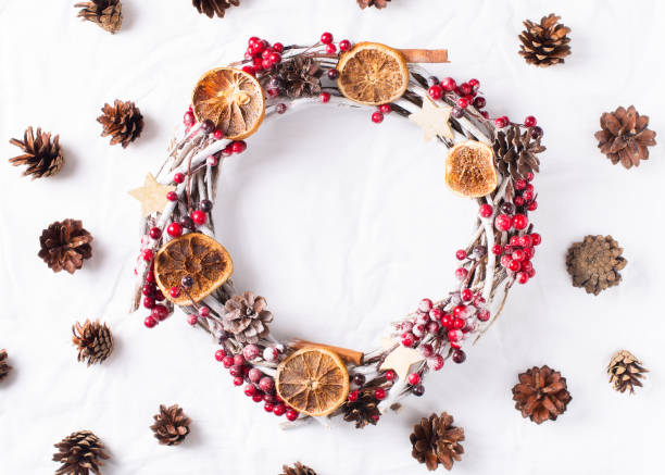 istock Wreath frame made of red berries and cone on white background. 1081282866