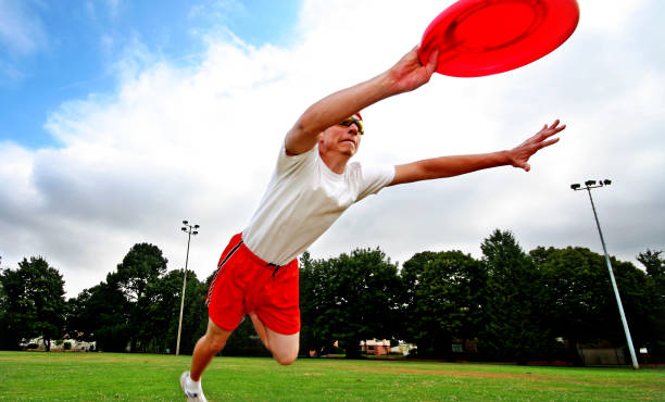 istock Young Man Diving and Catching Frisbee in Field 108128314
