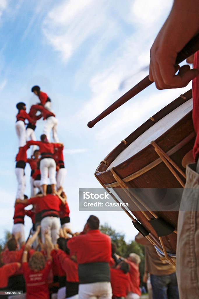 Castellers and Man Playing Drum on Sunny Day Istockalypse Barcelona Castellers Stock Photo