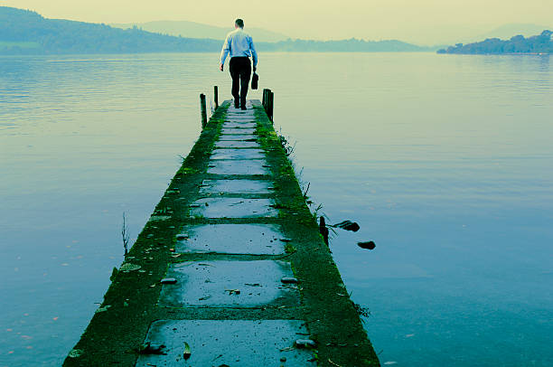istock Businessman Walking Down Path Towards Lakes Edge 108128642