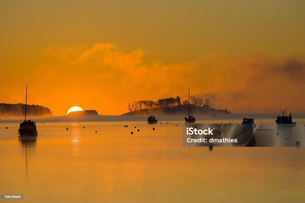 Silhouettes of Fishing Boats in Harbor at Sunrise  Awe Stock Photo
