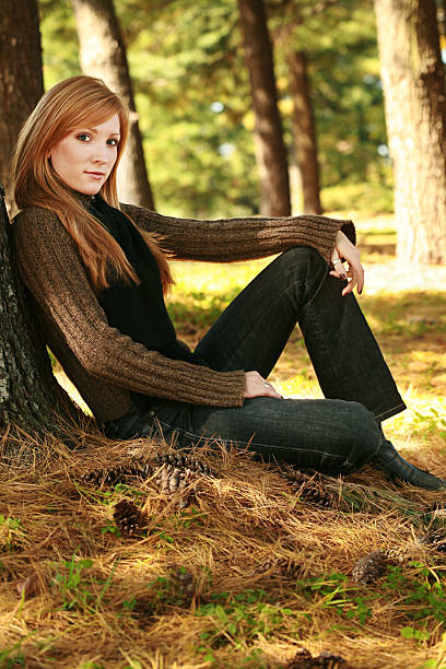 Young Woman Leaning Against Tree  modelce stock pictures, royalty-free photos & images