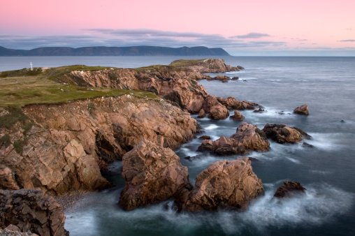 Rocky beach in Acadia National Park, Maine with view of Otter Cliffs at sunrise.