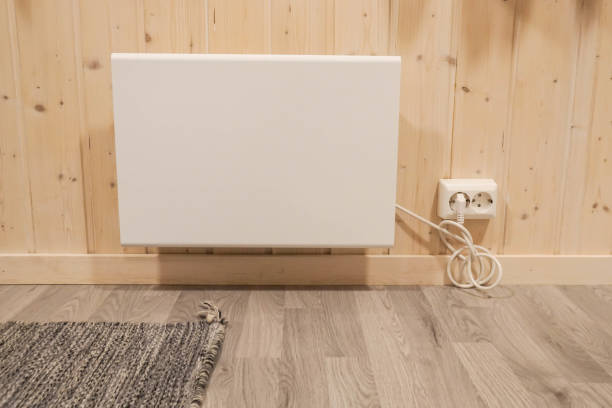 plug-in heater at house wall in winter stock photo